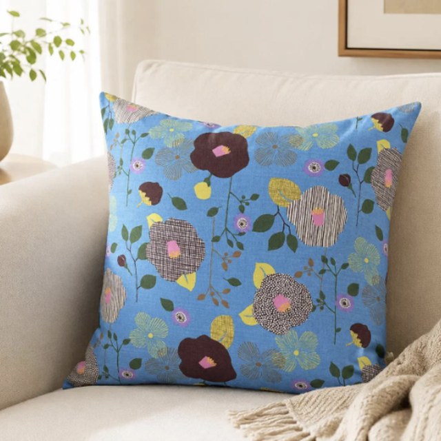 Sky Blue Botanical Bloom pillow cover on a cream armchair
